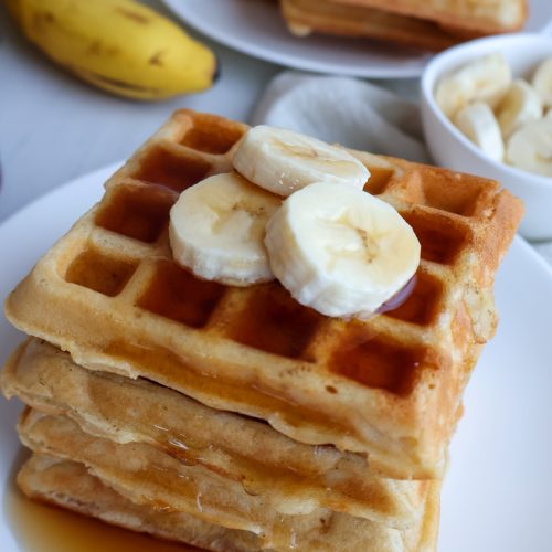 Stack of Gluten-Free Waffles with syrup and bananas